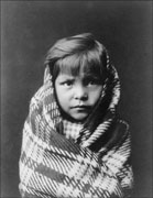 Old photo of a Navajo child wrapped in a blanket